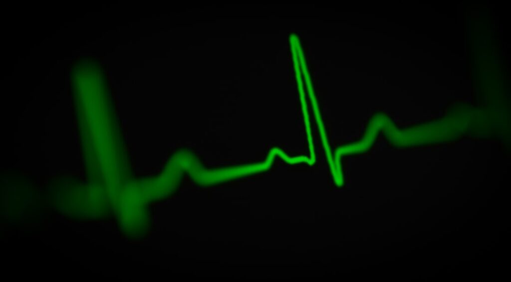 Green electrocardiogram line against a black background