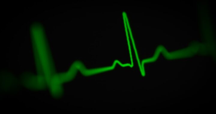 Green electrocardiogram line against a black background
